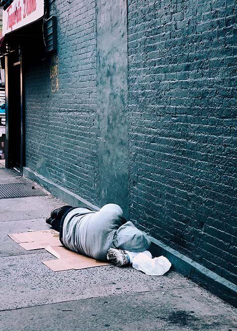man sleeping in alley